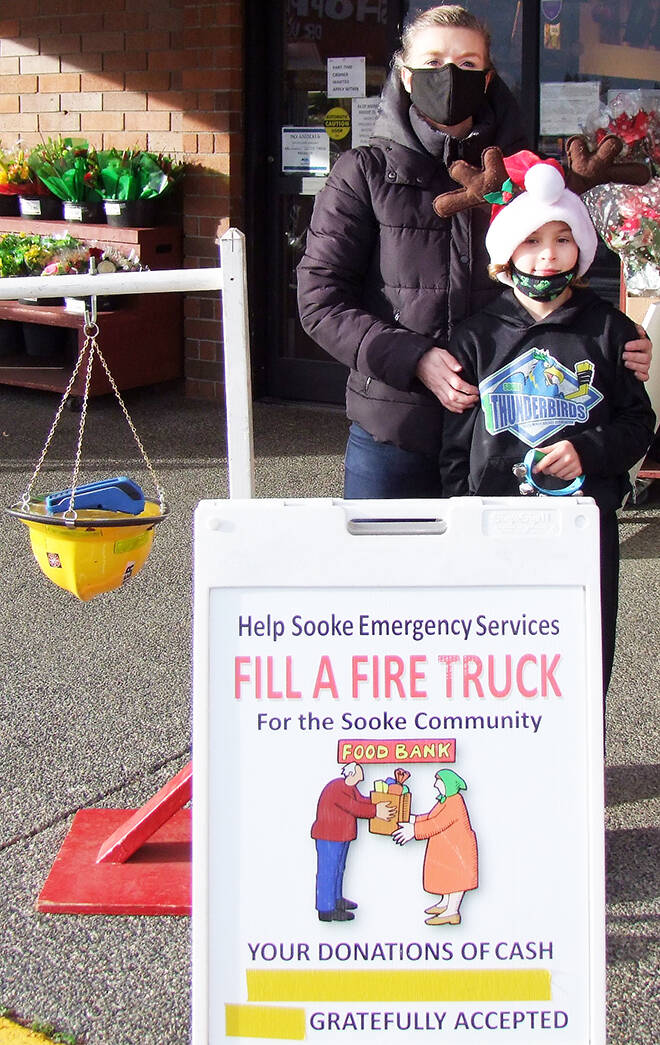 Volunteers, Christina Moog and her son Kayden, were out in full force last weekend for Sooke Fire Rescue’s Fill-a-Truck. Firefighters are raising money for the Sooke Christmas Bureau, Sooke Food Bank and other charities. (Andrew Lang - Sooke News Mirror)