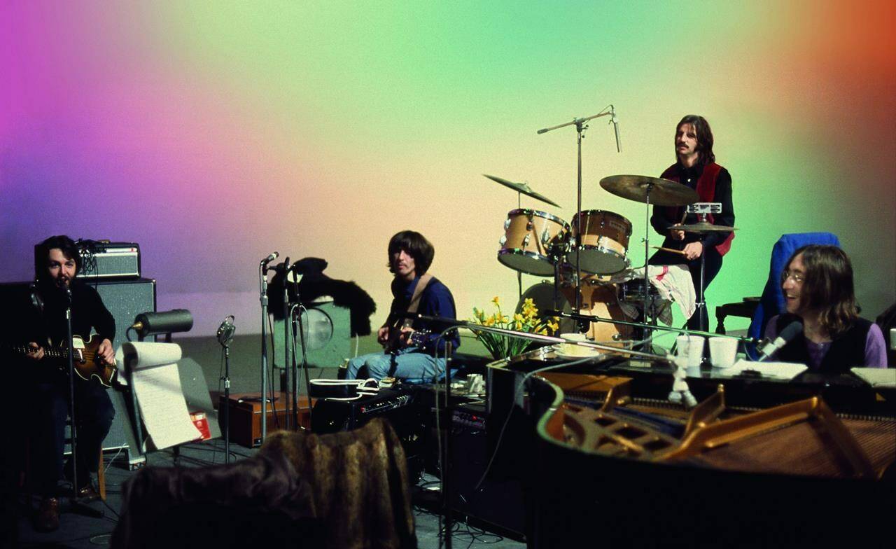 This image released by Disney+ shows, from left, Paul McCartney, George Harrison, Ringo Starr and John Lennon in a scene from the nearly 8-hour Peter Jackson-produced documentary “Get Back.” (Disney+ via AP)