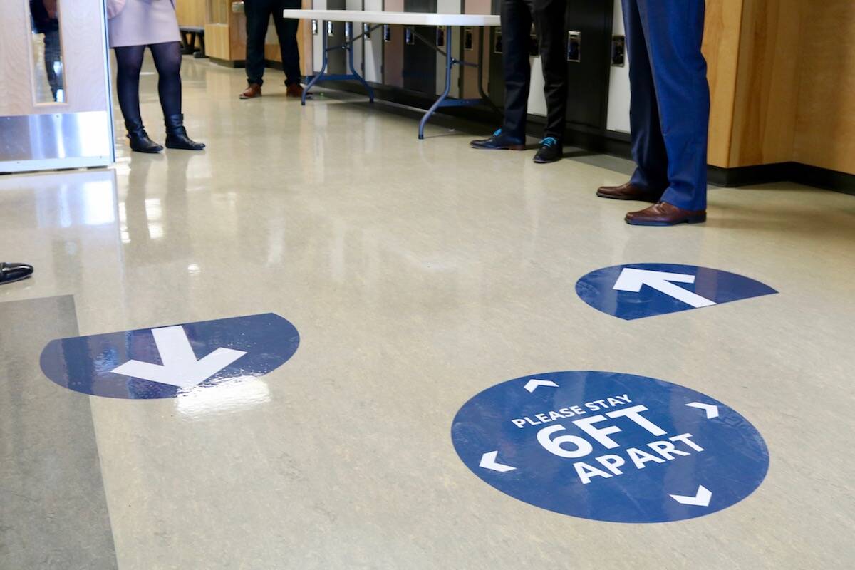 Floor signs at Belmont Secondary School instruct students to stay six feet apart. (Black Press Media file photo)