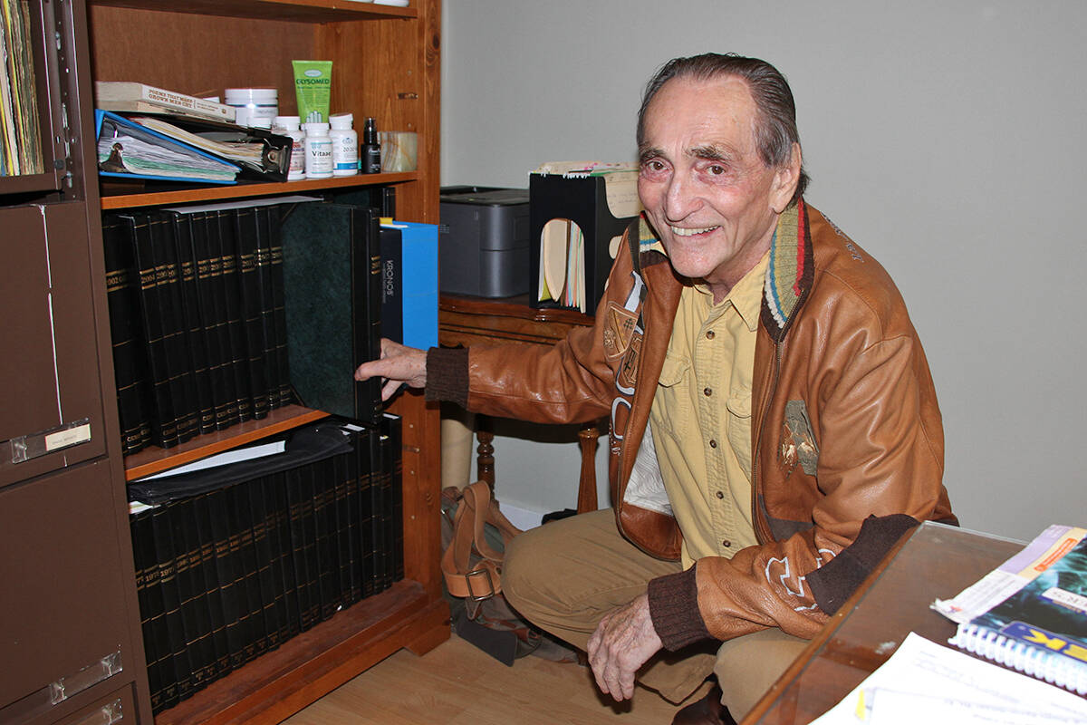 Greater Victoria entrepreneur turned author, Earl Large, grabs one of the many personal journal books he filled up during his decades in business. His new book, Living Large, contains poems he wrote in the books to start every month. (Don Descoteau/News Staff)