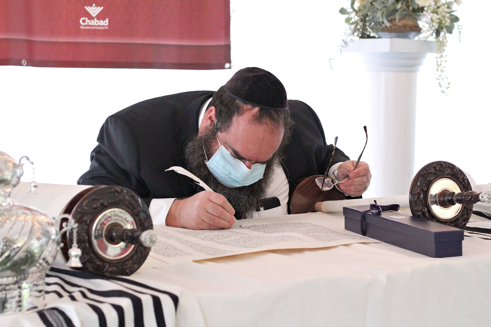 Ritual scribe Rabbi Yechiel Baitelman inks some of the final letters on Nanaimo’s first-ever Torah scroll on Sunday, Dec. 12, at the Inn on Long Lake. (Greg Sakaki/News Bulletin)