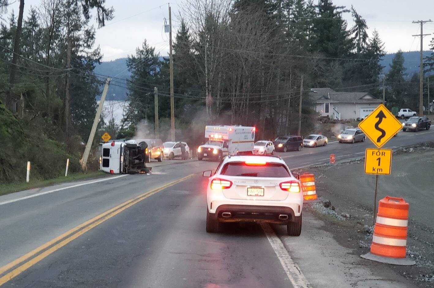A vehicle is turned on its side on Sooke Road in a crash. (Courtesy of Kirk Moseley)