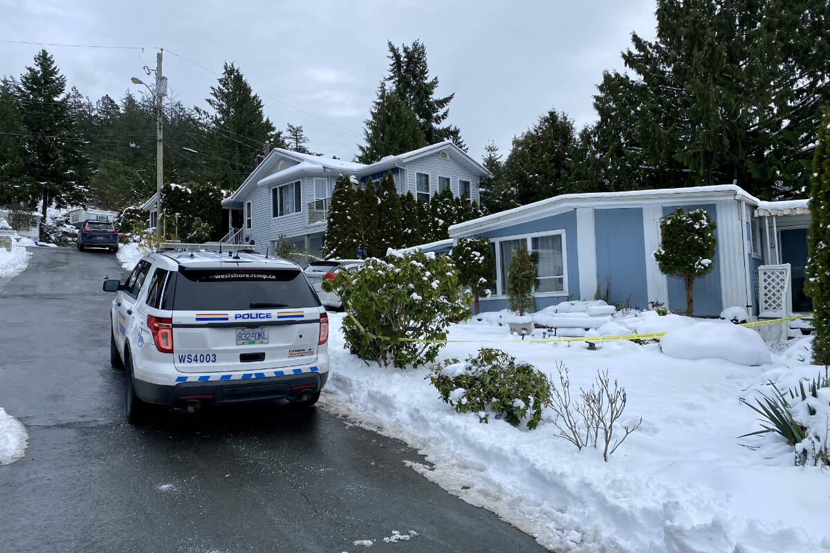 An RCMP cruiser and police tape are seen in front of a home in the Arbutus Ridge Estates mobile home community on Selwyn Road, Langford, Saturday. (Justin Samanski-Langille/News Staff)