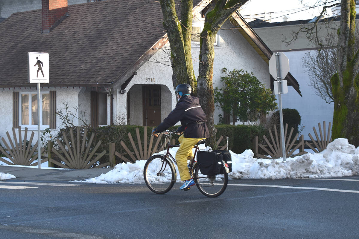 Cyclists such as this person braving the cold along Bevan Avenue in Sidney, stand to benefit from Sidney’s proposed active transportation plan. Town staff plan to submit a request for proposals in late January to create the plan. (Wolf Depner/News Staff)