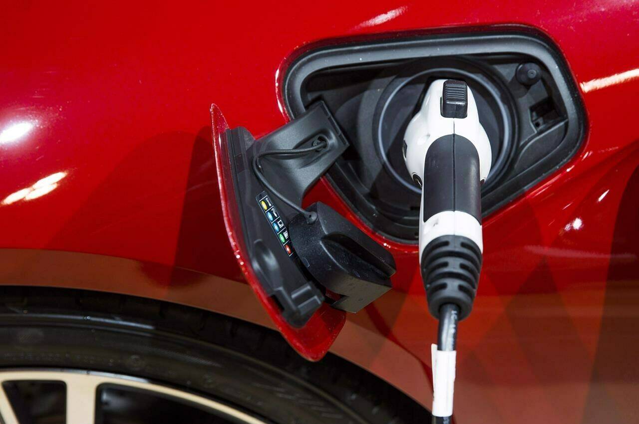 An electric plug is connected to a BMW i8 vehicle during the Canadian International Auto Show in Toronto, Thursday February 16, 2017. Transport Minister Omar Alghabra says the government is looking to overhaul the rebate program for electric vehicles to more closely align with the kinds of cars Canadians actually want to buy. THE CANADIAN PRESS/Mark Blinch