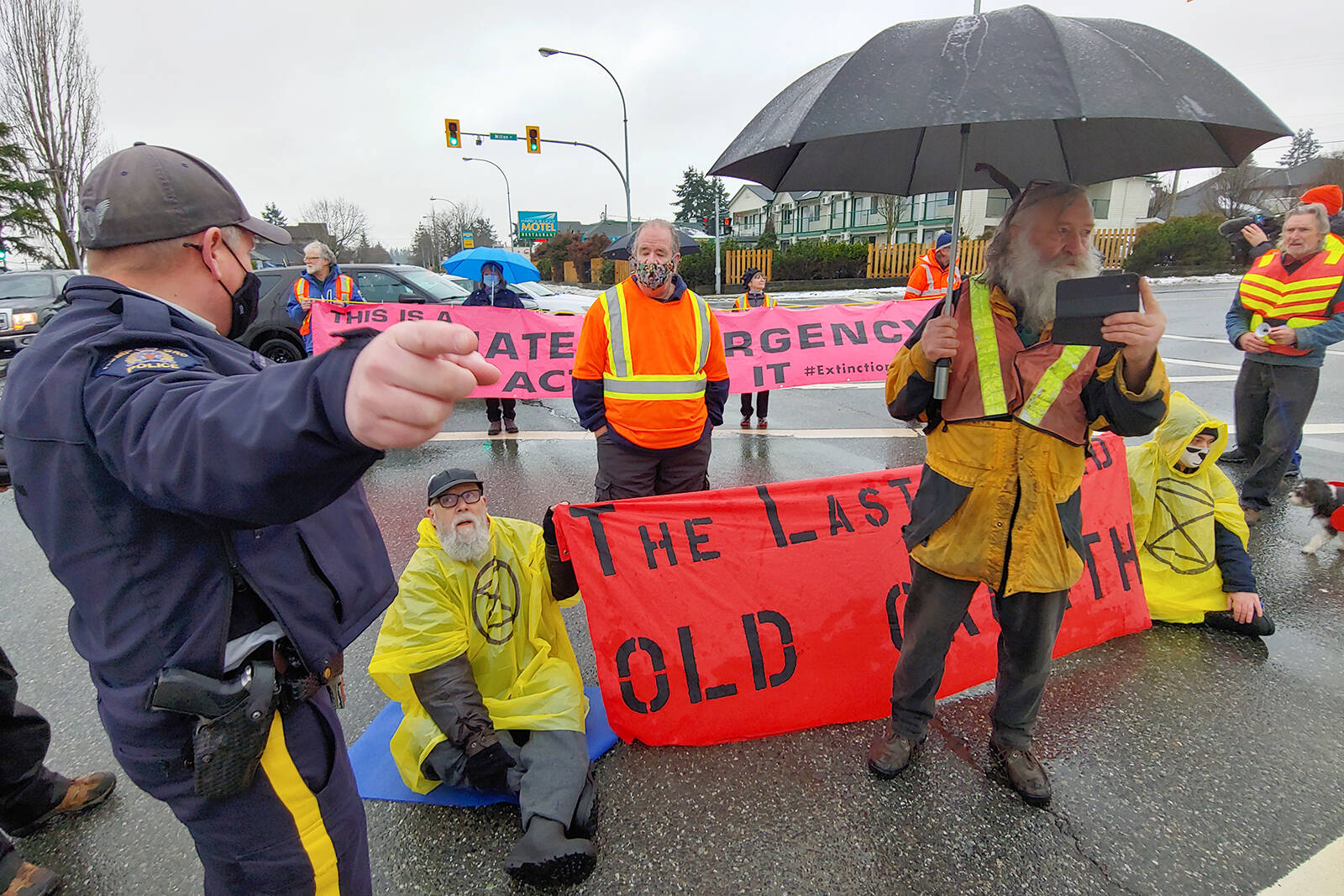 Nanaimo RCMP speak with Extinction Rebellion protesters who are blocking the intersection of Nicol and Milton streets on Monday, Jan. 10, demanding an end to old-growth logging. (Chris Bush/News Bulletin)