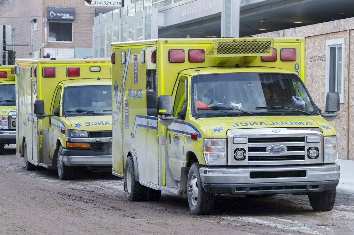 A row of ambulances is seen outside a hospital in Montreal, on Monday, January 10, 2022. Prime Minister Justin Trudeau says Ottawa will do all it can to help provinces and territories cope with the fifth wave of the COVID-19 pandemic, as infections fuelled by the Omicron variant threaten to overwhelm health systems. THE CANADIAN PRESS/Paul Chiasson