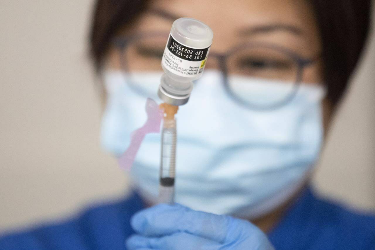 A nurse prepares a COVID-19 vaccine shot before the opening of a mass vaccination clinic in Mississauga, Ont., Friday, Dec. 24, 2021. The Black Health Alliance says Quebec's proposed tax on the unvaccinated risks further entrenching inequities in Canada's pandemic response and eroding trust in the government. THE CANADIAN PRESS/Chris Young