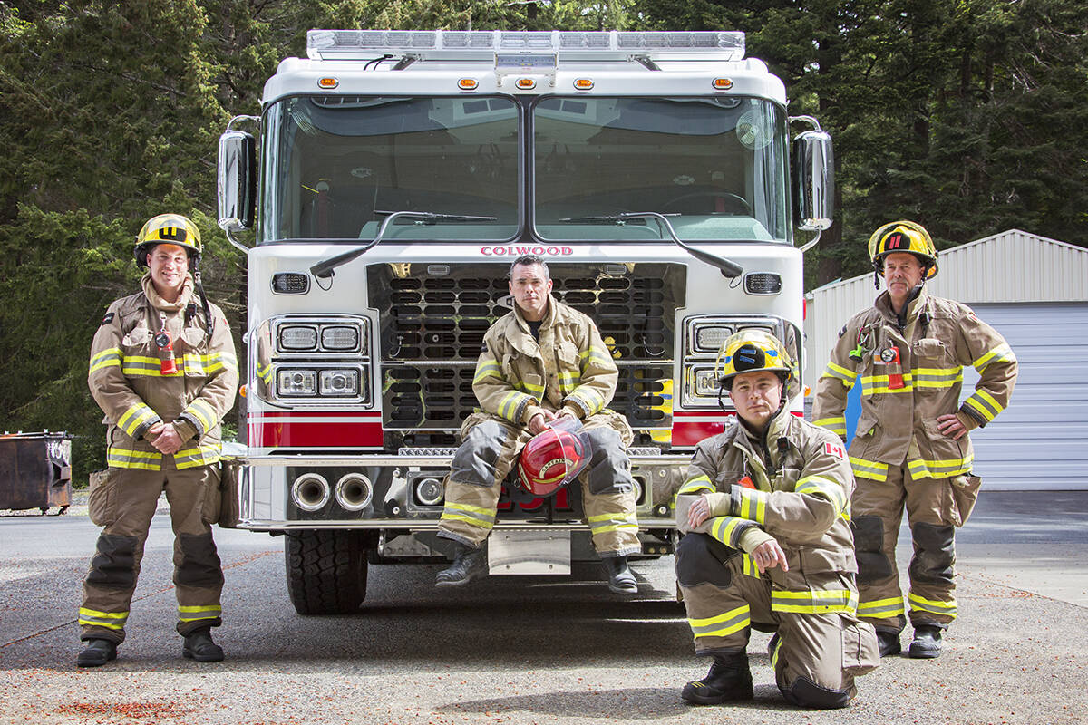 Firefighters Michael Poole (from left), Captain Bryan Erwin, Bryan McNeil and Josh Pettigrew get acquainted with Colwood Fire Rescue’s new engine. (Katherine Engqvist/News Staff)