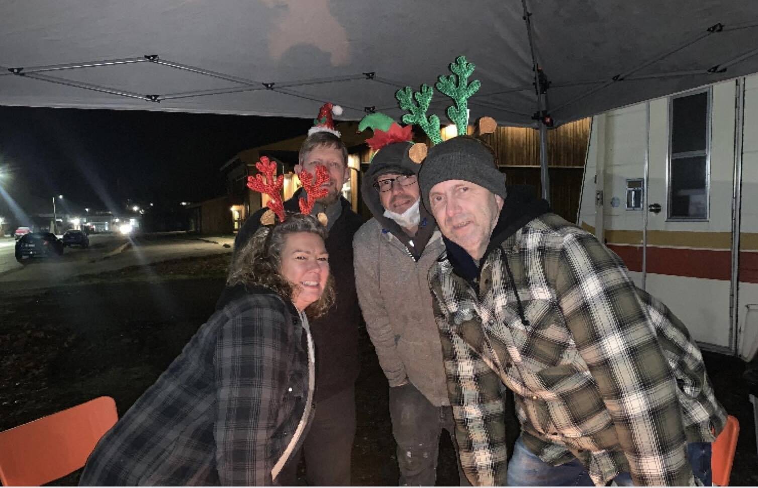 Lisa George, left, and other volunteers with the Grassroots Homelessness Coalition set up the trailer and awning used in their pop-up warming centres in the spare lot beside the Port Alberni Friendship Center in early December 2021. (PHOTO COURTESY GRASSROOTS H. COALITION)