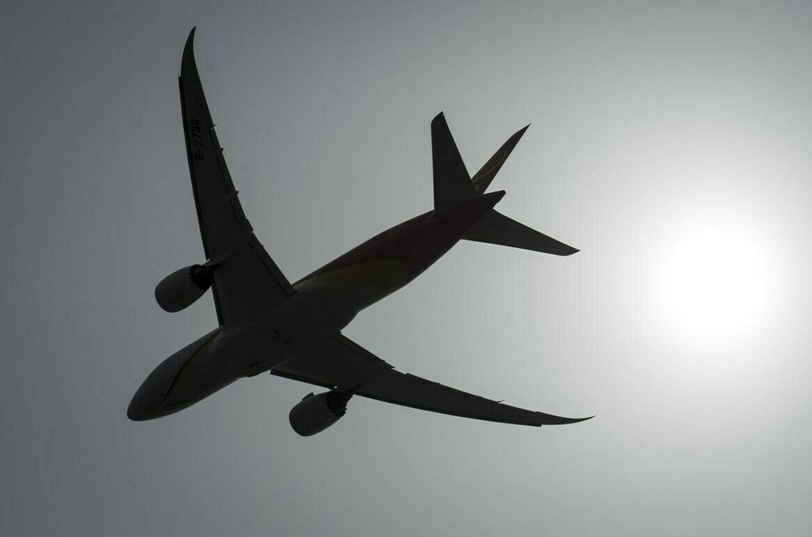 A plane is silhouetted as it takes off from Vancouver International Airport in Richmond, B.C., Monday, May 13, 2019. THE CANADIAN PRESS/Jonathan Hayward