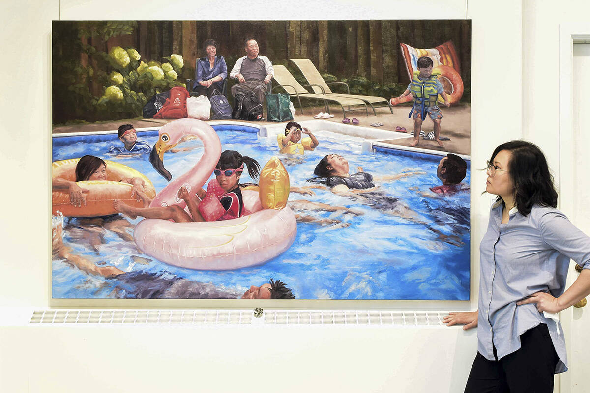 Victoria artist Chrystal Phan poses with her painting Pool Party at the Chapel Gallery ahead of her exhibit opening Jan. 21. (Courtesy of Chrystal Phan)