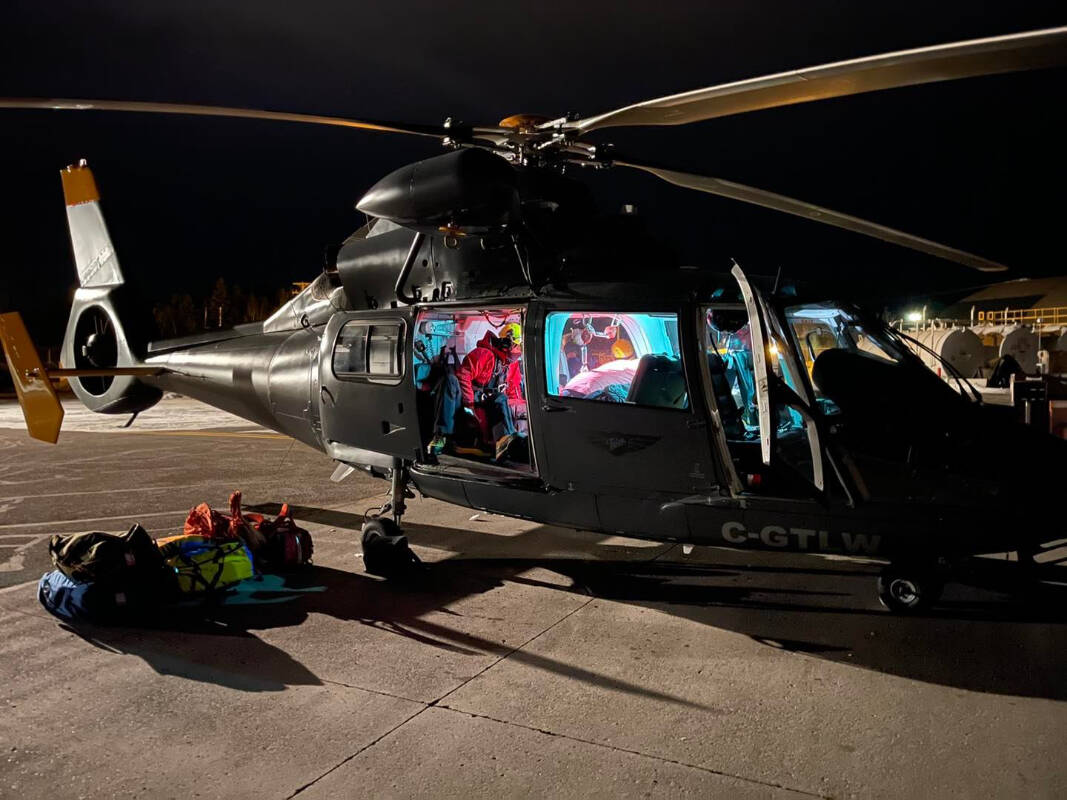 North Shore Rescue members prepare to transfer an injured snowmobiler after landing at Williams Lake Airport. (North Shore Rescue photo)
North Shore Rescue members prepare to transfer an injured snowmobiler after landing at Williams Lake Airport. (North Shore Rescue photo)