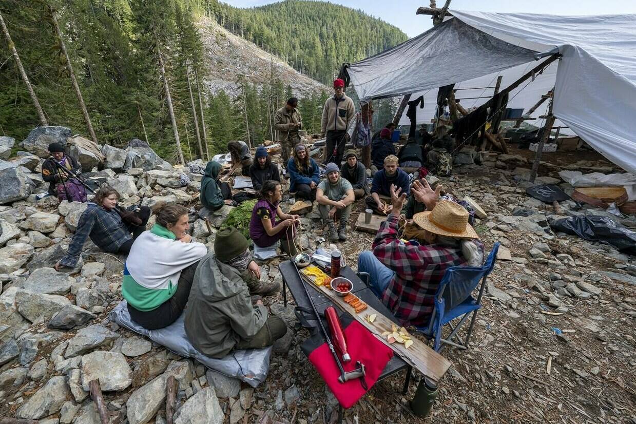 People listen to Pacheedaht elder Bill Jones in the Fairy Creek logging area near Port Renfrew, B.C. Monday, Oct. 4, 2021. THE CANADIAN PRESS/Jonathan Hayward