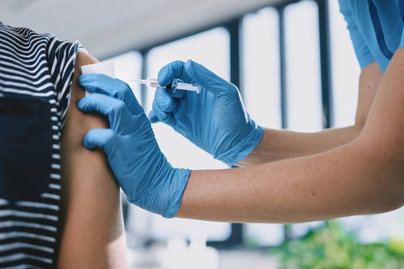 A child is caught between two parents with conflicting opinions on whether they should be vaccinated (Adobe stock)