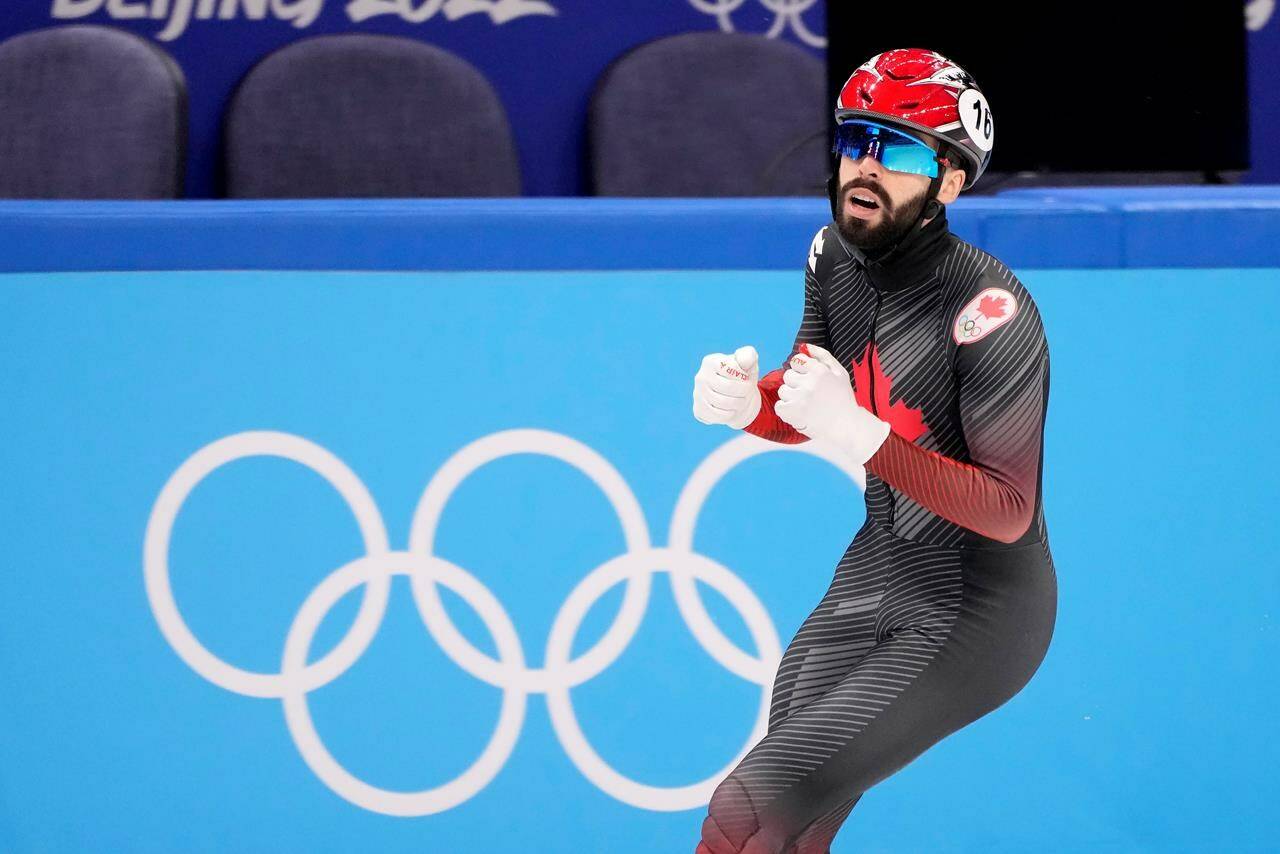 Canada’s Steven Dubois celebrates his bronze medal finish at the finish line for the men’s 500 metre short-track speed skating final at the Olympic Winter Games in Beijing, Sunday, Feb. 13, 2022. THE CANADIAN PRESS/Paul Chiasson