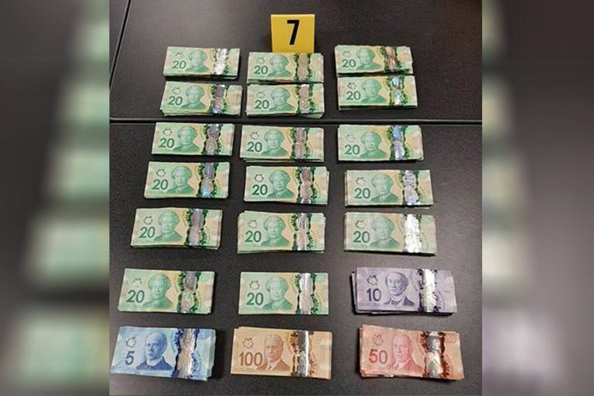$20,000 in cash, along with quantities of drugs police say are consistent with a drug trafficking operation, were seized by police in Langford last week. (Photo courtesy of VicPD)