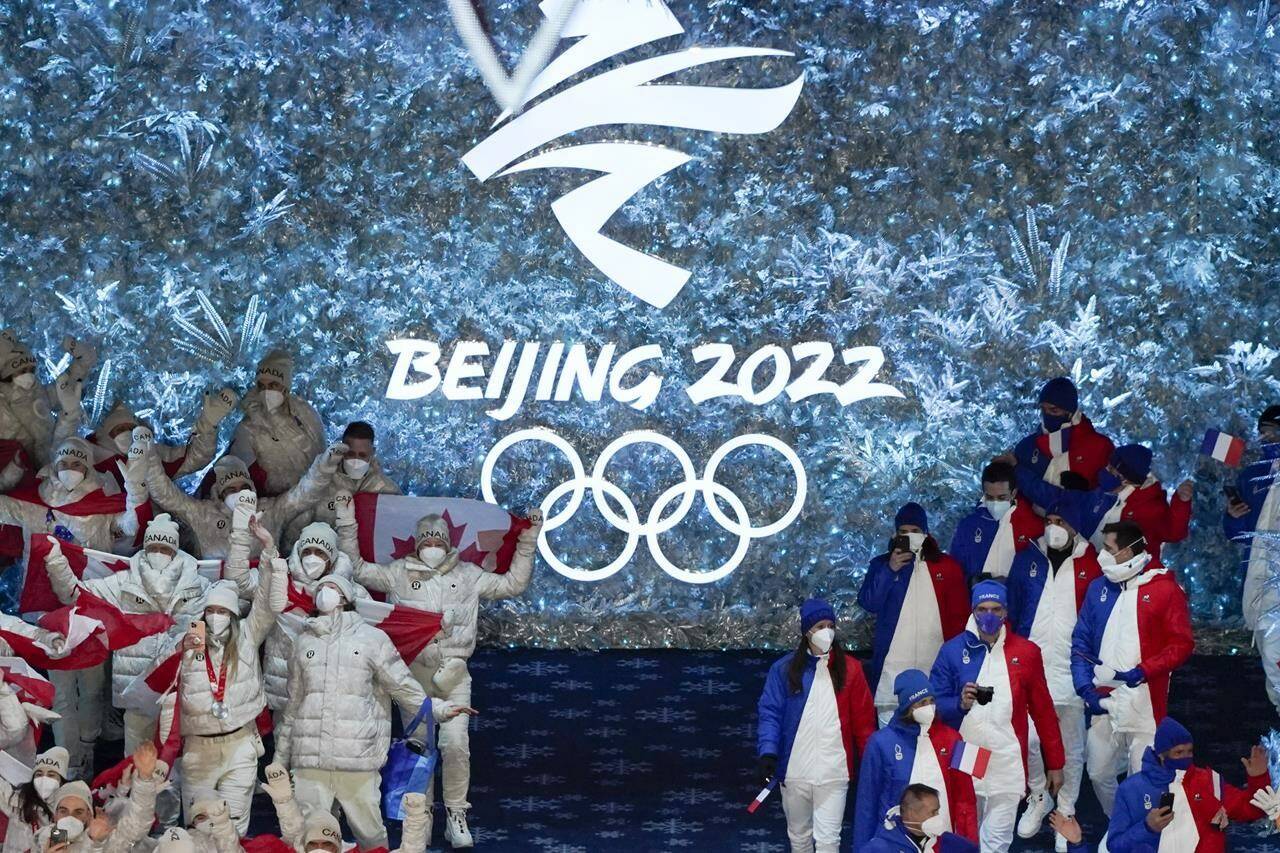 Canada, left, and France arrive at the closing ceremony of the 2022 Winter Olympics, Sunday, Feb. 20, 2022, in Beijing. THE CANADIAN PRESS/AP-Brynn Anderson