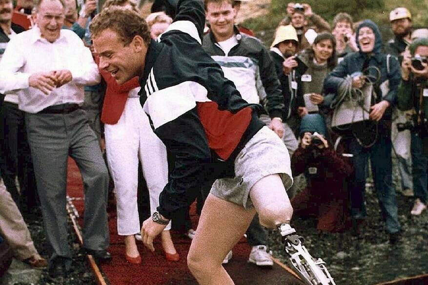 Steve Fonyo, who raised millions for cancer research by running across Canada on an artificial limb, has died. Fonyo is shown dippping his artifical limb in the Pacific Ocean in Victoria after completing his cross-country run in this 1985 photo. THE CANADIAN PRESS/Chuck Stoody