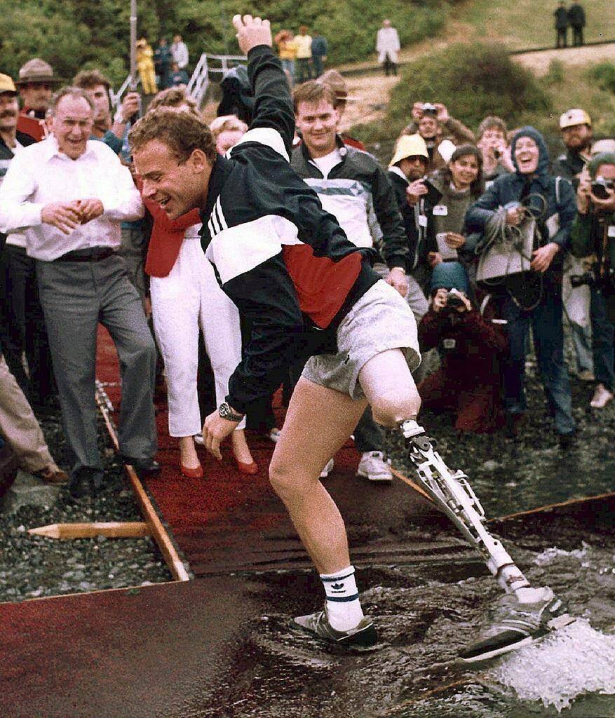 Steve Fonyo, who raised millions for cancer research by running across Canada on an artificial limb, has died. Fonyo is shown dippping his artifical limb in the Pacific Ocean in Victoria after completing his cross-country run in this 1985 photo. THE CANADIAN PRESS/Chuck Stoody