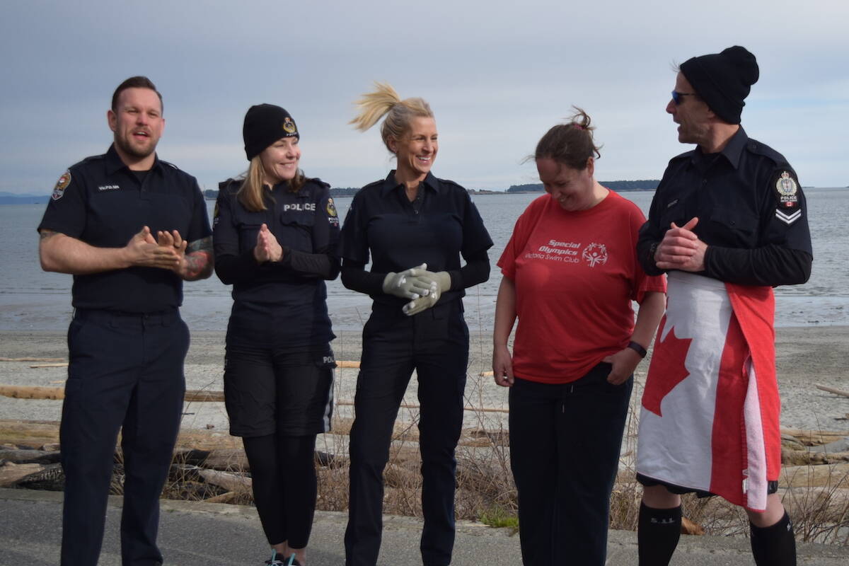 Special Olympian Sheena Morrison and Greater Victoria police officers Pat Briant, Lisa Bruschetta, Julie Chanin and Dan Gilano took dip off Willows Beach on Feb. 23, in anticipation and promotion for the CRD’s virtual Polar Plunge being held March 5 to 20. Proceeds to the CRD’s Polar Plunge go towards supporting special athletes. (Kiernan Green/News Staff)