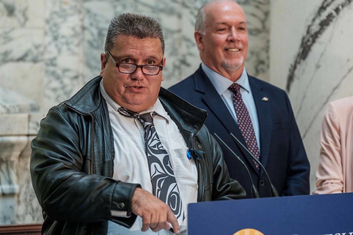 B.C. Premier John Horgan listens as ‘Namgis Chief Don Svanvik speaks at an event at the B.C. legislature on phasing out salmon farms in the Broughton Archipelago north of Vancouver Island, Sept. 19, 2019. (B.C. government)