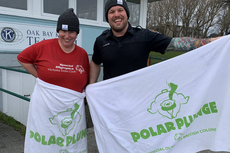 Special Olympics BC athlete Sheenagh Morrison and Victoria police Const. Dan Galano took a preliminary dip at Willows Beach before a previous Polar Plunge fundraiser event. The 2022 Polar Plunge remains virtual. (Courtesy of VicPD)