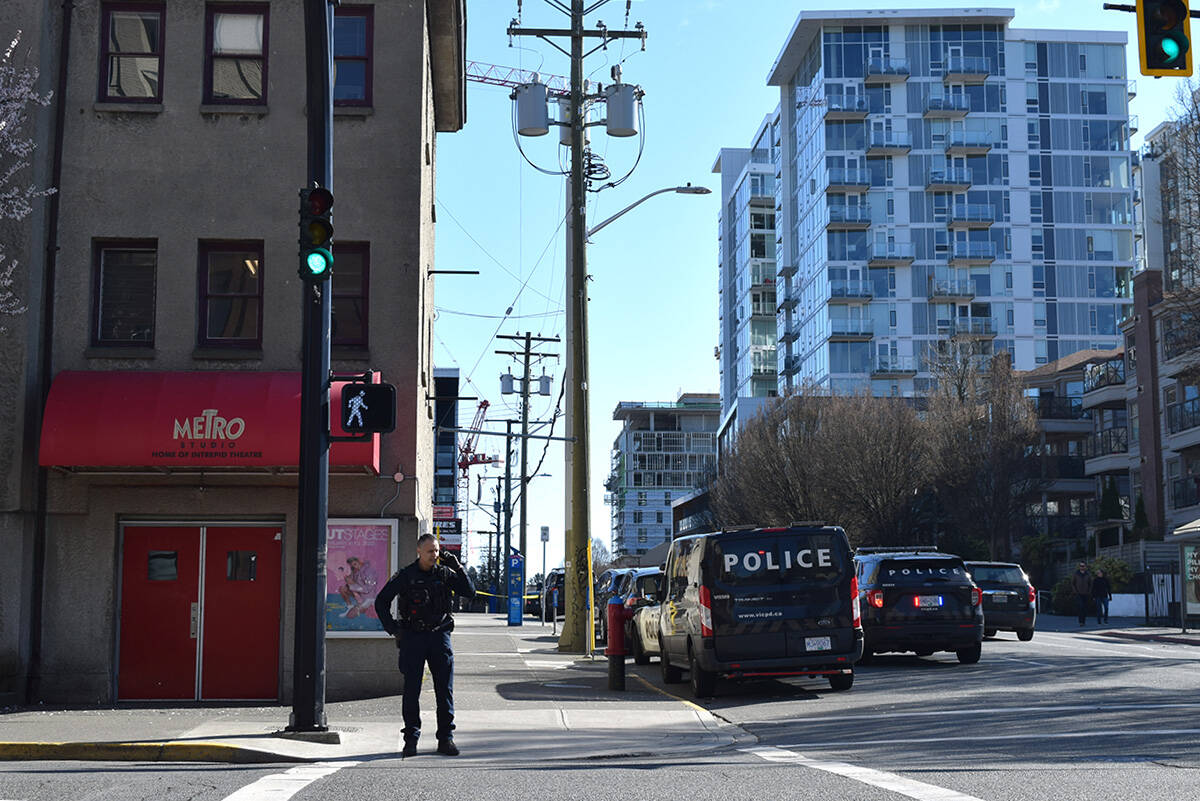 Police at the corner of Johnson and Pandora streets, following an incident involving a man camped on a Pandora Street rooftop on March 6. (Kiernan Green/News Staff)