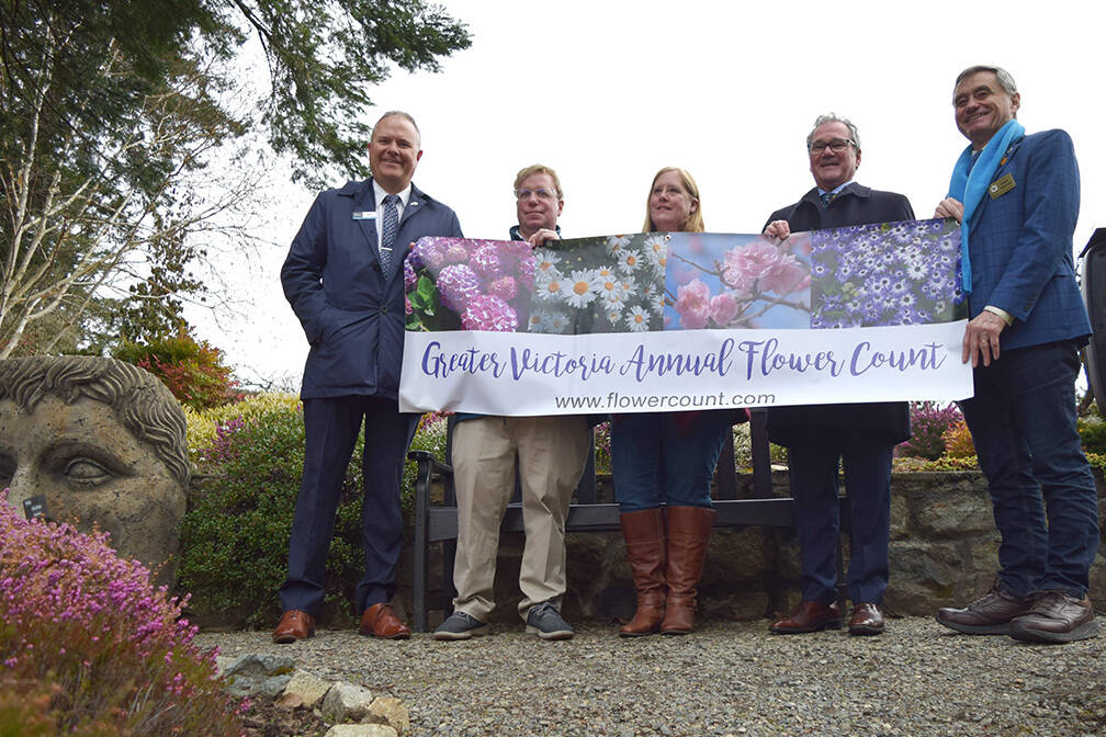 Greater Victoria Chamber of Commerce board chair John Wilson (left), Destination Greater Victoria CEO Paul Nursey, Horticultural Centre of the Pacific general manager Deborah Donahue, chamber CEO Bruce Williams and Saanich Mayor Fred Haynes celebrate the start of the 2022 Greater Victoria Flower Count, happening March 9 to 16. (Kiernan Green/News Staff)