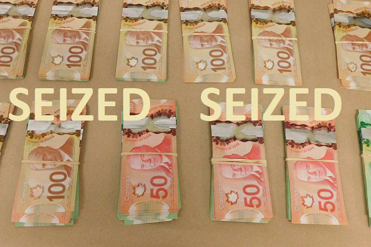 Police photo shows some of the mre $26,000 in cash seized along with drugs when a seach warrant was executed Dec. 10. One man has been charged with posession of drugs and a prohibited device. Campbell river RCMP photo
