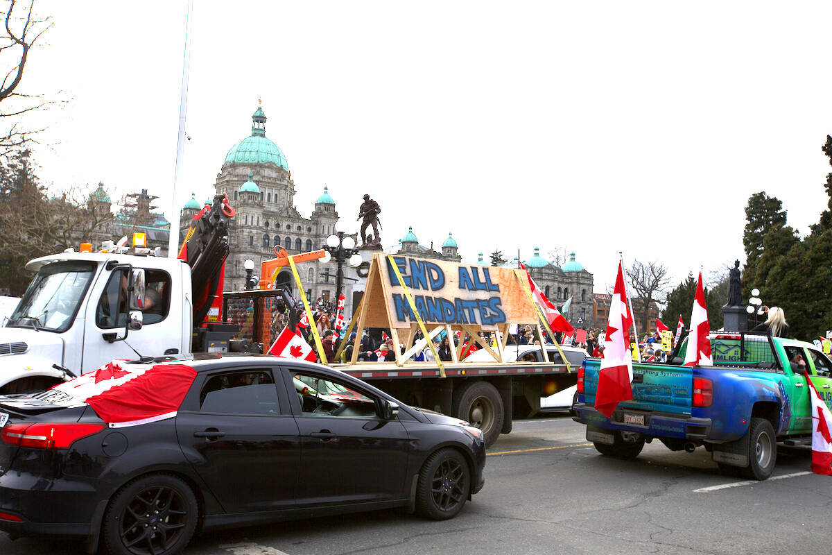 Drivers protesting COVID-19 mandates travel in front of the B.C. legislature on Jan. 29. More protesters are expected to descend upon the city in late March following a rallying cry from one of Canada’s “freedom convoy” organizers. (Black Press Media file photo)