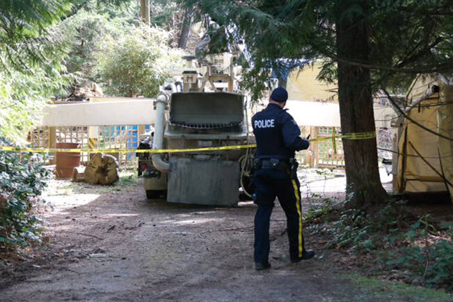 An RCMP officer on scene on Berry Point Road on Gabriola Island, where a fatal work-site incident happened in March 2021. (News Bulletin file)