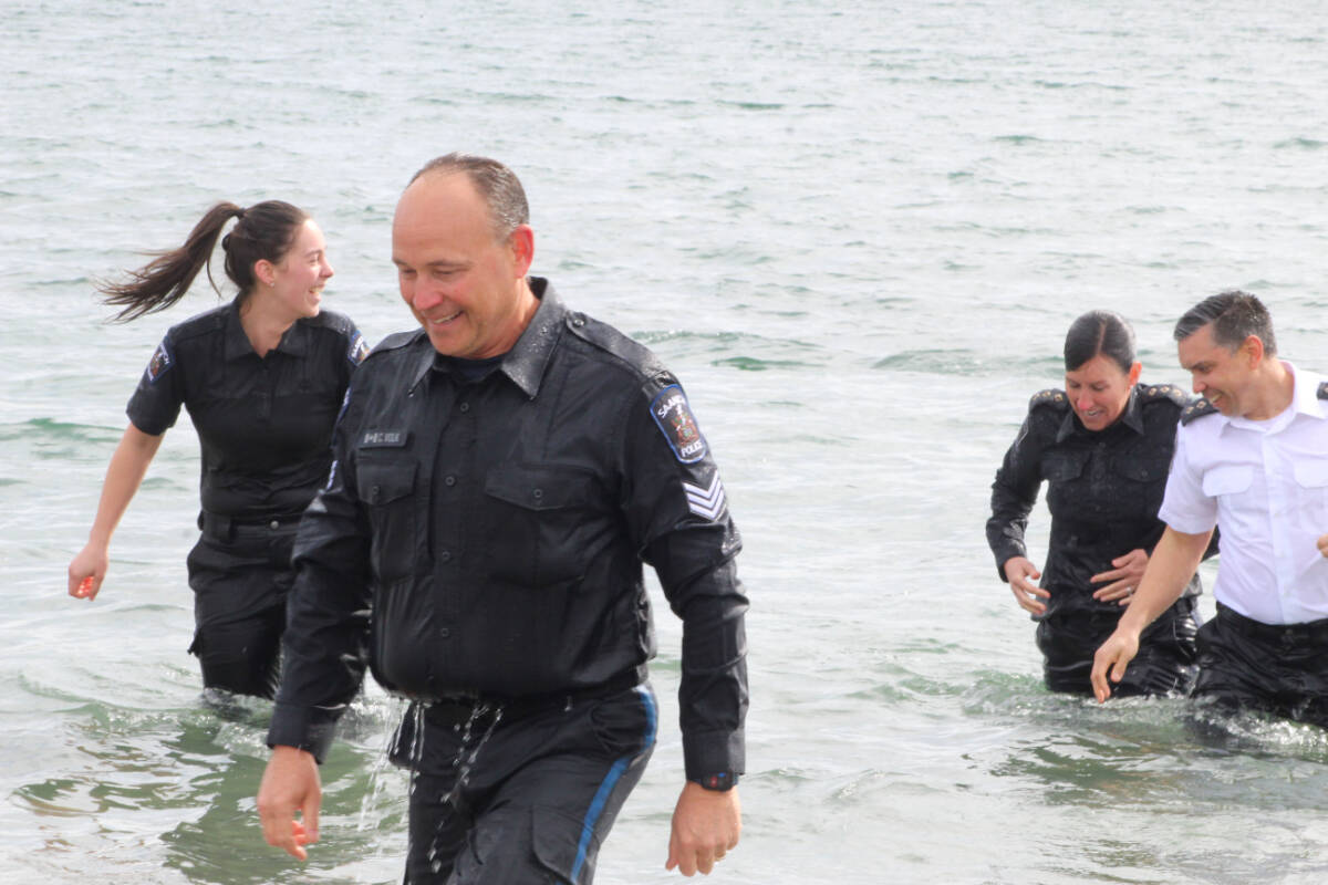 Members of the Saanich Police Department brave the cold waters off Gyro Beach on March 15 to show their support for Special Olympics B.C. (Megan Atkins-Baker/News Staff)
