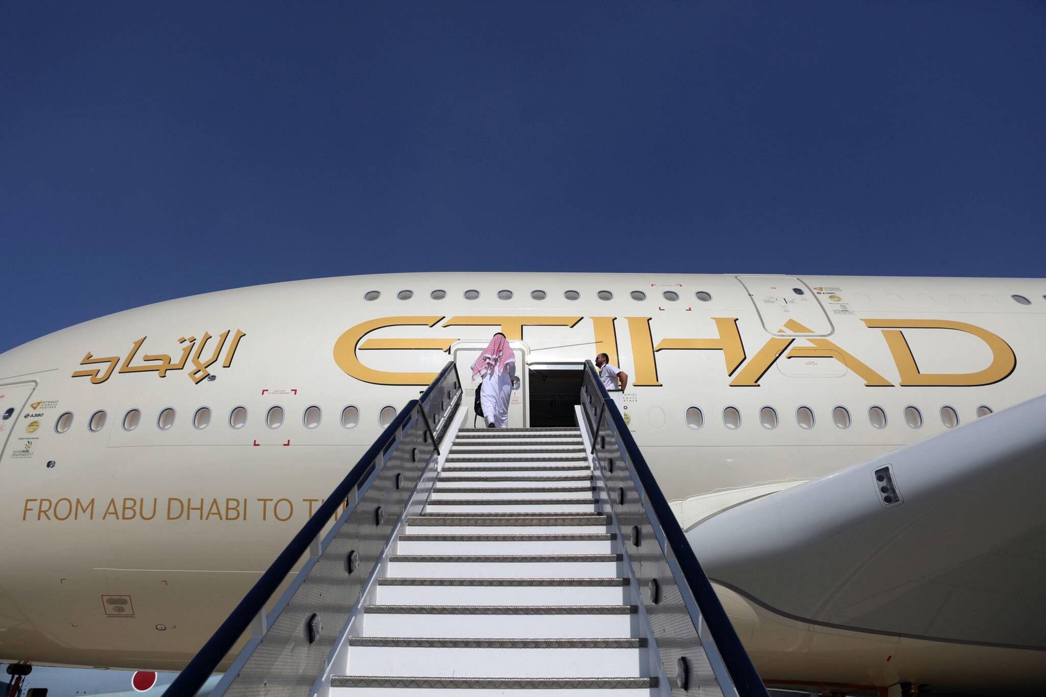 An attendee enters an Airbus A380 passenger aircraft, operated by Etihad Airways, during the 15th Dubai Air Show in Dubai, United Arab Emirates, on Nov. 13, 2017. Bloomberg photo by Natalie Naccache.