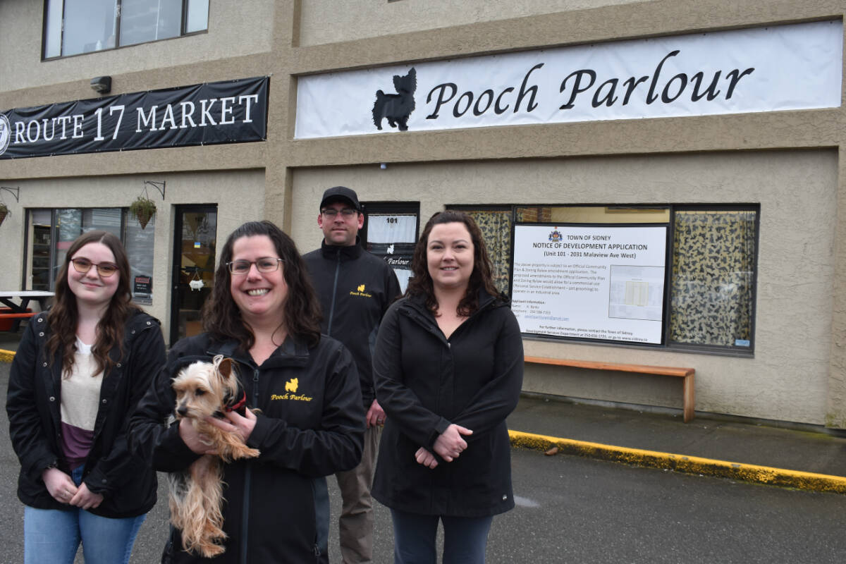 Owner Kathy Banks (front) with her dog Abby, along with employees Kaylyn Paterson (left) and Sherry Bell (right), and husband James Anson stand outside Pooch Parlour. The municipality closed the business earlier this month for operating without the proper business license. (Wolf Depner/News Staff)