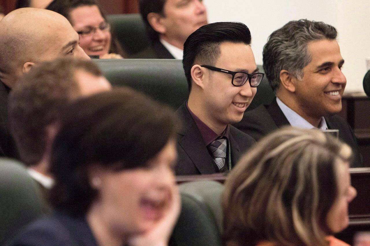 Edmonton-Southwest MLA Thomas Dang (centre) laughs along with his colleagues during an introductory meeting with all newly-elected MLAs in Edmonton on Tuesday, May 12, 2015. THE CANADIAN PRESS/Amber Bracken