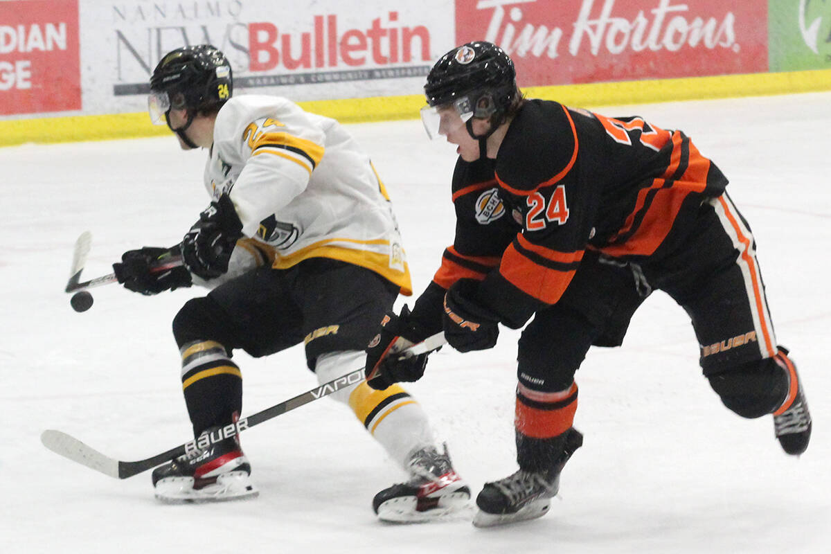 Coquitlam Express player Luke Roberts is checked by Nanaimo Clippers opponent Jake Hewitt during Sunday’s BCHL game at Frank Crane Arena. (Greg Sakaki/News Bulletin)