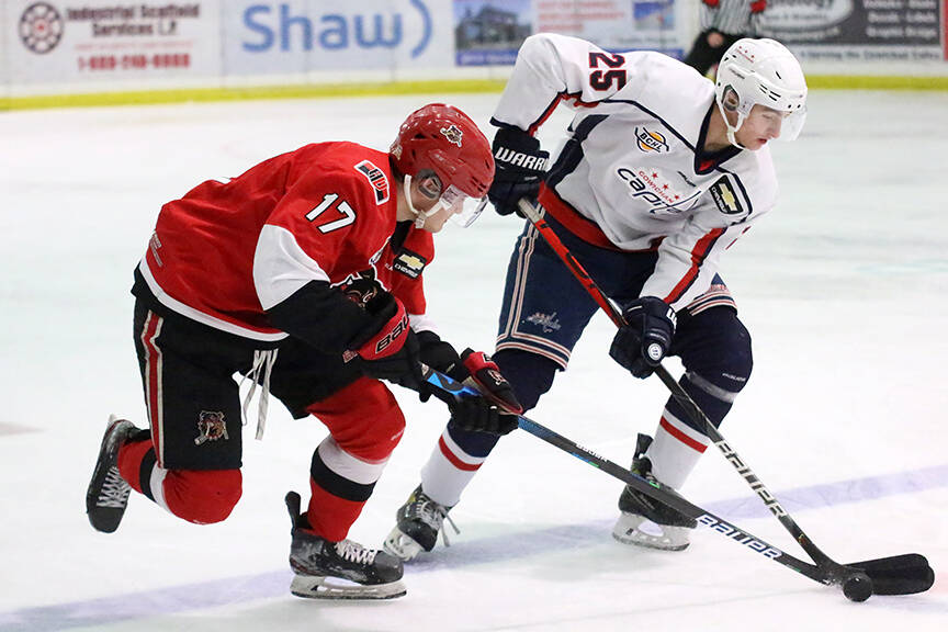 Alberni Valley Bulldogs forward Josh Zary battles with Nick Marciano of the Cowichan Valley Capitals during a game in Duncan on Oct. 1, 2021. The Bulldogs and Caps will face off for round one of the BCHL playoffs. (KEVIN ROTHBAUER / BLACK PRESS)
