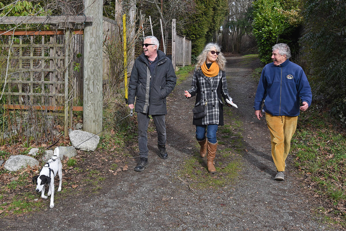February 14, 2022 - Christopher Causton, Susan Lundy, Bruce Cameron and dog Zorro take a walk through Oak Bay's back alleys and thru-ways.  Don Denton photo
