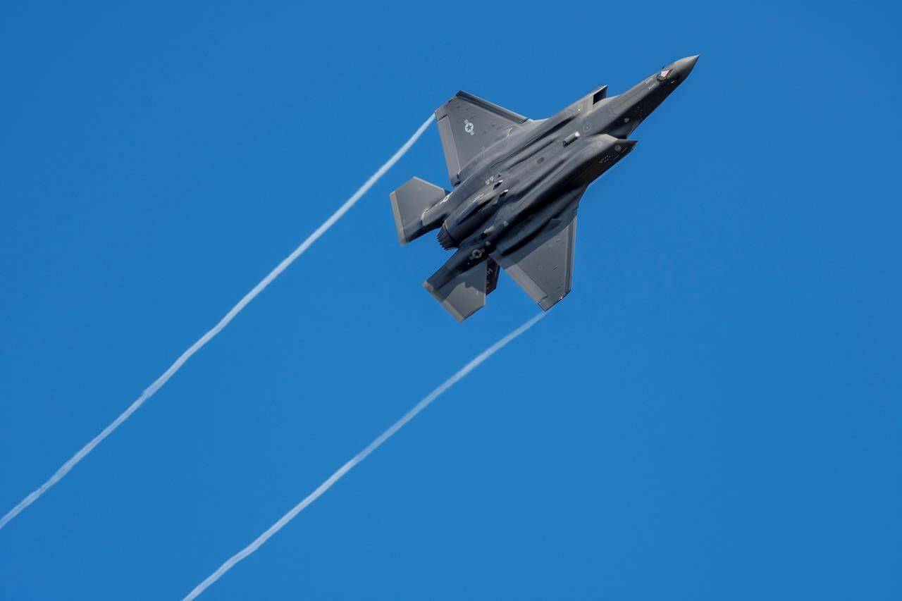 A U.S. F-35 fighter jet flies over the Eifel Mountains near Spangdahlem, Germany, Wednesday, Feb. 23, 2022. The Liberal government is expected to announce this afternoon that it will enter into final negotiations on purchasing the F-35. (Harald Tittel/dpa via AP)