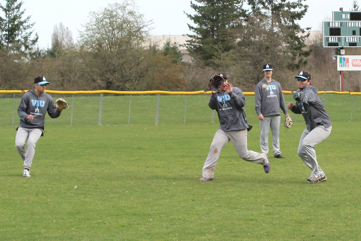 VIU Mariners teammates have some fun in left field during a pop-up drill at practice last week at Mariner Field. The team starts the CCBC regular season this Saturday, April 2, at Serauxmen Stadium. (Greg Sakaki/News Bulletin)