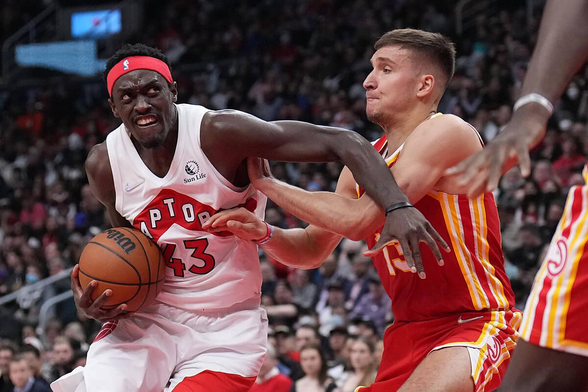 Toronto Raptors forward Pascal Siakam (43) drives to the basket as Atlanta Hawks guard Bogdan Bogdanovic (13) defends during first half NBA basketball action in Toronto on Tuesday, April 5, 2022. THE CANADIAN PRESS/Nathan Denette