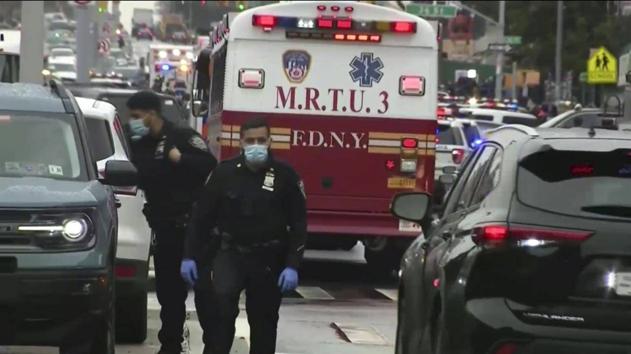 This still image provided by WABC shows law enforcement gathering at the scene of a shooting in the Brooklyn borough of New York on Tuesday, April 12, 2022. Law enforcement sources say five people were shot at a subway station in Brooklyn . Fire personnel responding to reports of smoke Tuesday morning at the 36th Street station in Sunset Park found multiple people shot and unexploded devices. (WABC via AP)