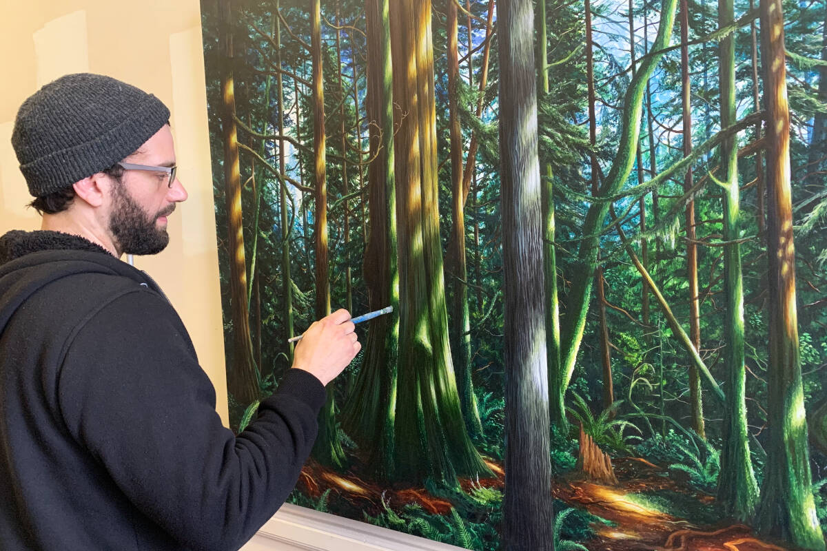 Artist Logan Ford, leasing agent for Rockslide Studio, works on a piece at the grassroots arts organization’s new home at 780 Blanshard St. Rockslide supports artists in the region by providing affordable studio and showcase space. (Megan Atkins-Baker/News Staff)