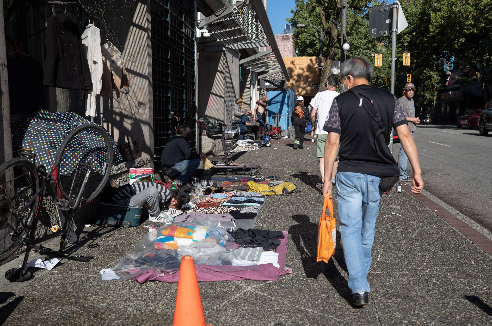 Various items are laid out for sale on the sidewalk on Hastings Street in the Downtown Eastside of Vancouver, on Wednesday, July 28, 2021. THE CANADIAN PRESS/Darryl Dyck