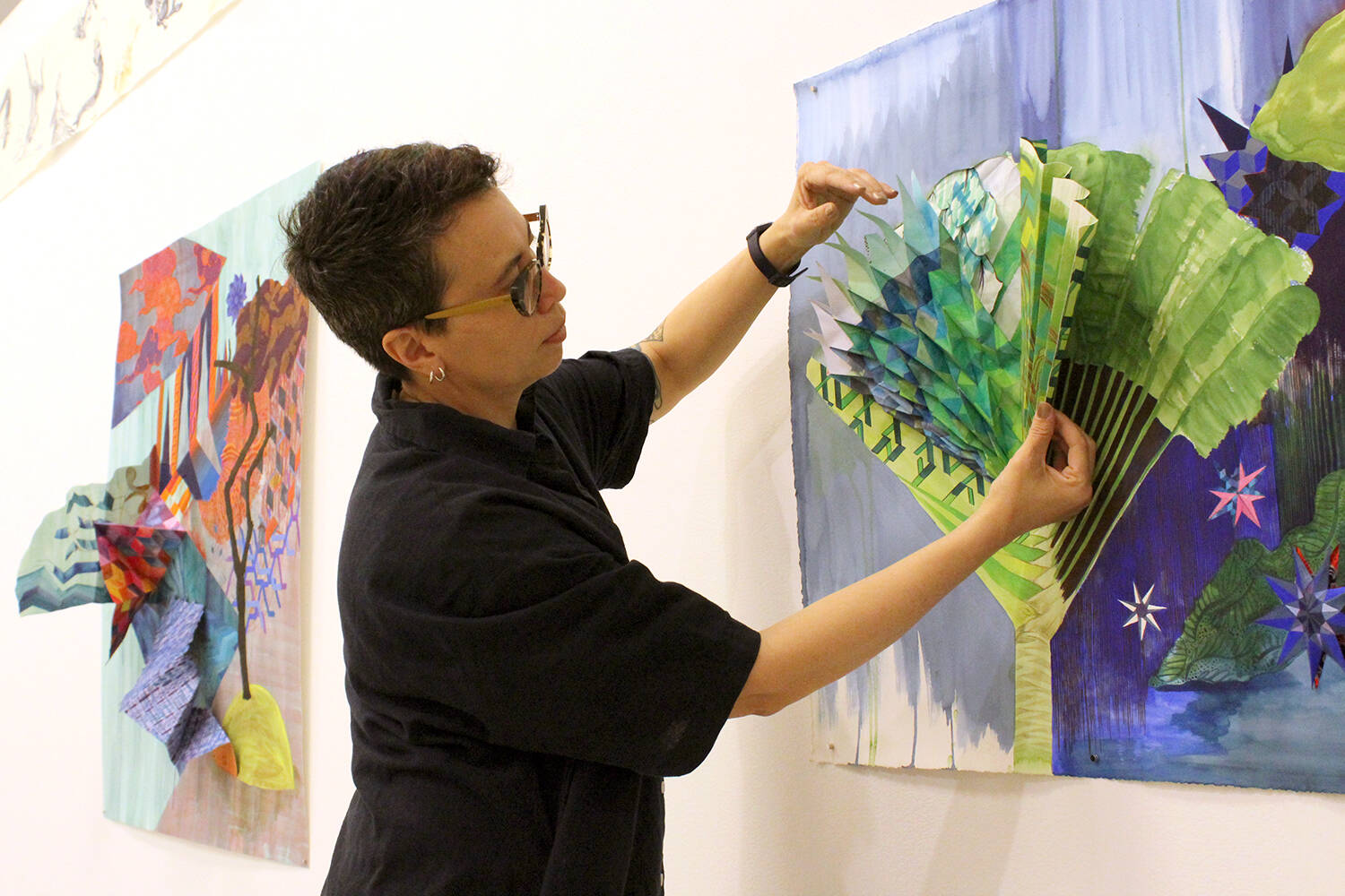 Diyan Achjadi adjusts a pop-up element of one of her pieces being shown at her ‘Carried Through the Water’ exhibition at the Nanaimo Art Gallery starting Friday, April 15. (Greg Sakaki/News Bulletin)