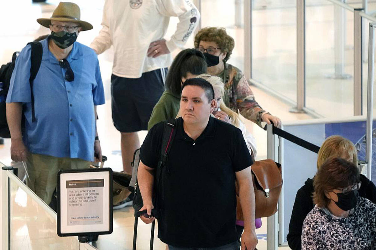 Travelers wait in a security line at Love Field in Dallas, Tuesday, April 19, 2022. The major airlines and many of the busiest airports dropped their mask requirements after a Florida judge struck down the CDC mandate and the Transportation Security Administration announced it wouldn’t enforce its 2021 security directive. (AP Photo/LM Otero)