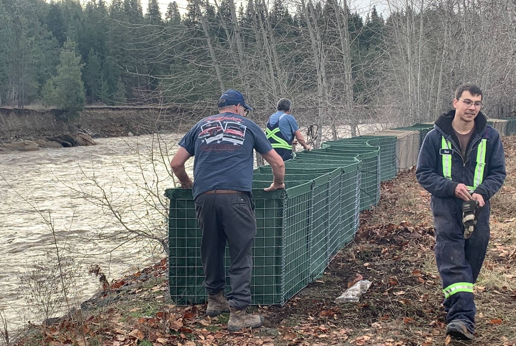 Town crews worked to build temporary dikes, in anticipation of a second flood. File photo Andrea DeMeer