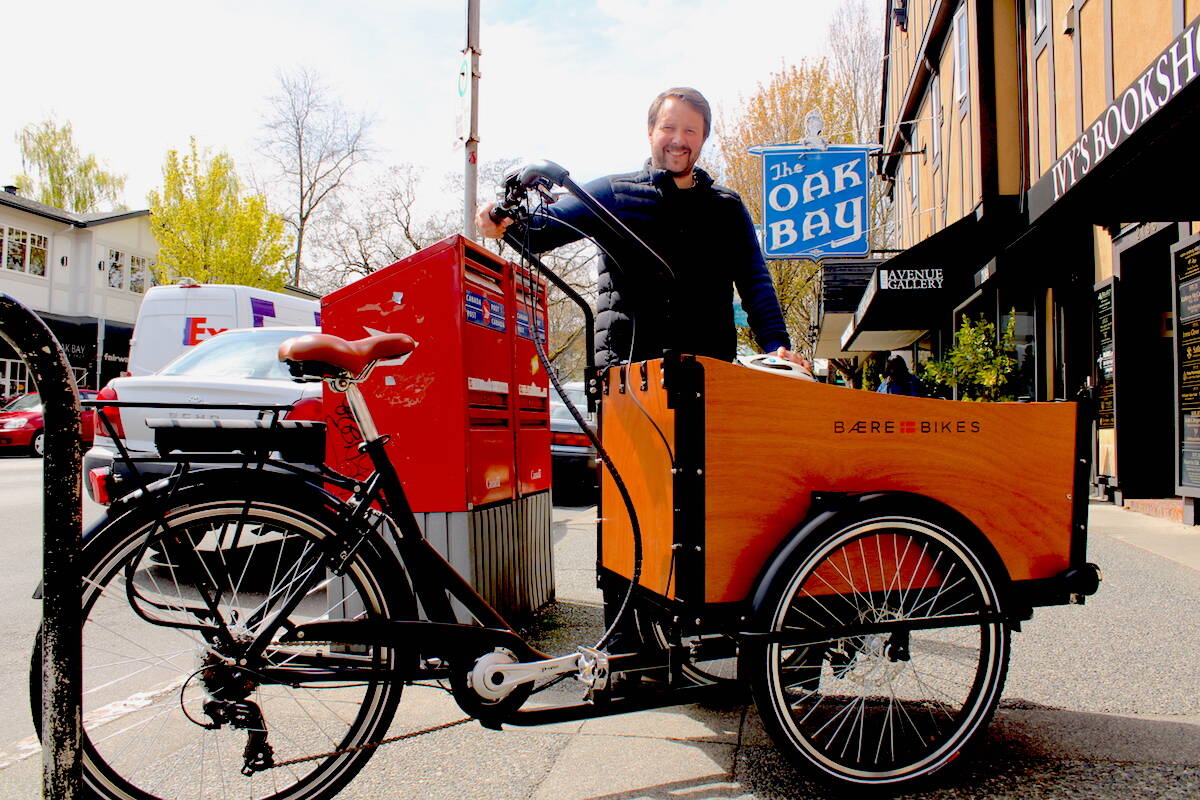 Baere Bikes co-founder Nicholas Jensen with one of his company’s electric cargo bikes on Oak Bay Avenue. (Jake Romphf/News Staff)