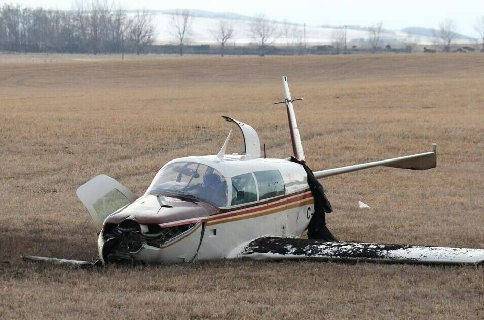 A small aircraft lies in a field next to the Trans-Canada Highway after a fatal crash near the Springbank Airport, west of Calgary, on Friday, April 22, 2022. The pilot killed in the crash has been identified as a plane crash west of Calgary has been identified as Michael James Wilton, president of FlightSimple, an aircraft sales company. THE CANADIAN PRESS/Dave Chidley